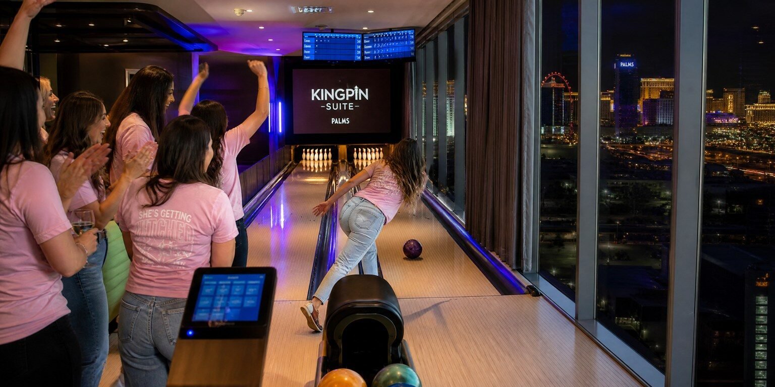 Friends bowling on private lanes inside the Kingpin Suite, one of the most famous Las Vegas themed rooms at Palms Casino Resort
