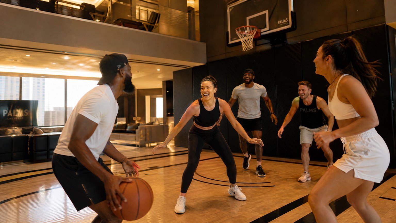 Friends playing basketball on the private court in the Hardwood Suite at Palms Las Vegas