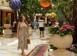 Woman walking through the flower-filled atrium at Wynn Las Vegas