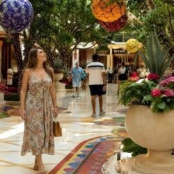 Woman walking through the flower-filled atrium at Wynn Las Vegas