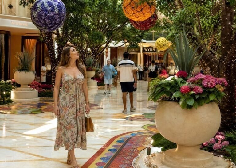 Woman walking through the flower-filled atrium at Wynn Las Vegas