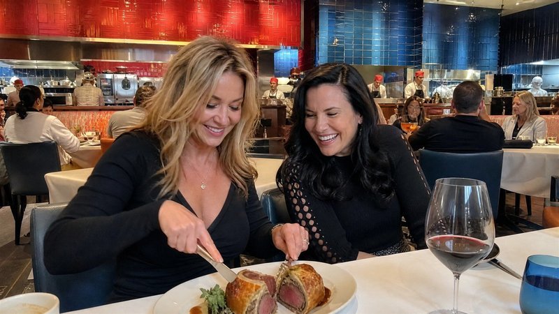 Two friends sharing beef Wellington at lunch at Gordon Ramsay Hell's Kitchen at Caesars Palace